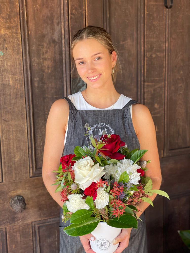 Christmas Arrangement In A White Ceramic Pot