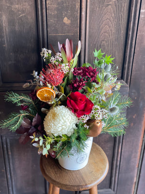 Christmas Arrangement In A White Ceramic Pot