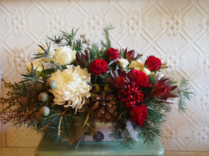 Xmas floral arrangement, long and low, white ceramic. Festive flowers, Xmas flowers.