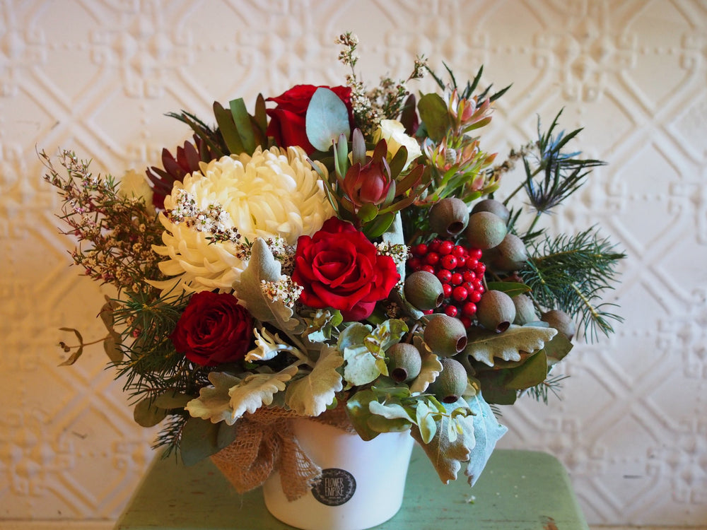 Christmas Arrangement In A White Ceramic Pot